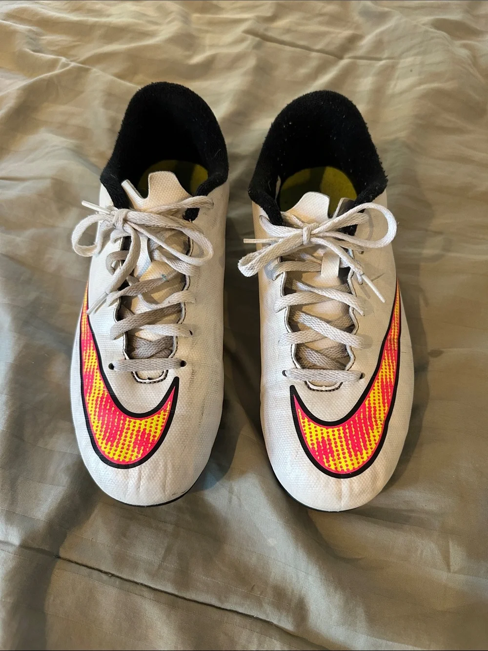 Nike Kids White Soccer Cleats with Neon Yellow and Pink Swoosh